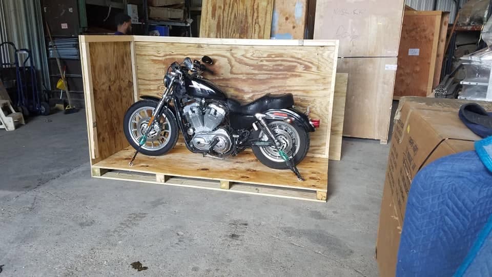 A motorcycle braced inside an open crate